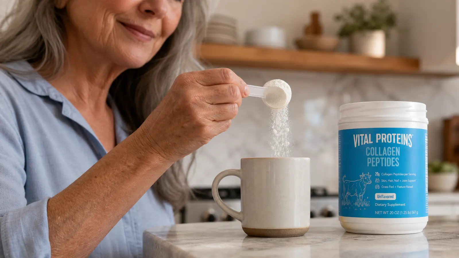 Close-up of a hand scooping unflavored collagen peptides powder from a jar labeled Vital Proteins into a mug of coffee
